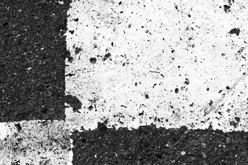 Asphalt surface with old paint on it close up. Abstract background black and white