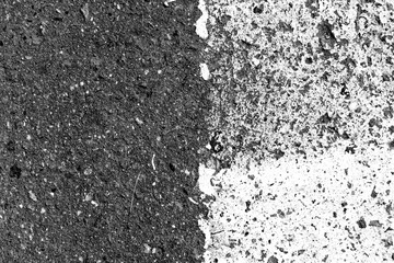 Asphalt surface with old paint on it close up. Abstract background black and white