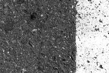 Asphalt surface with old paint on it close up. Abstract background black and white