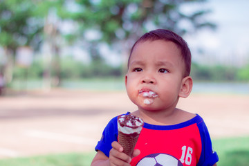 children eating ice-cream are happiness  and funny in park. close up portriat asian cute little children  at thailand