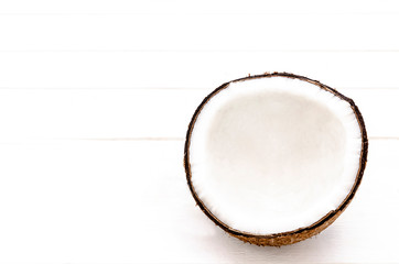 half coconut isolated on white wooden background