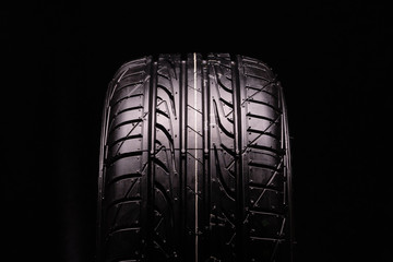 new summer tire, tire tread. Close-up, black background