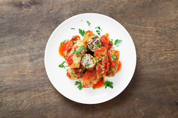Traditional stuffed cabbage rolls with minced meat and rice, served in a tomato sauce.