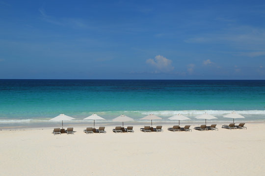 Beach chairs and umbrella on a beautiful Caribbean beach at Harbor Island, Bahamas
