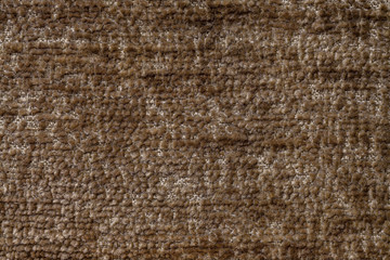 Light brown fluffy background of soft, fleecy cloth. Texture of textile closeup