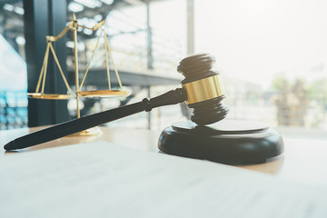 Judge gavel with Justice lawyers having team meeting at law firm background. Concepts of Law and...