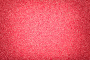 Light red matt suede fabric closeup. Velvet texture of felt.