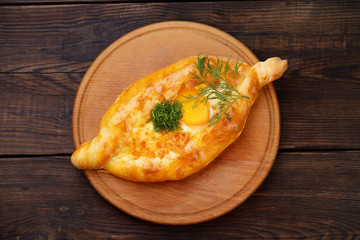 Ajarian khachapuri, traditional Georgian meal. Baked bread with melted cheese and egg filling. National pastry snack