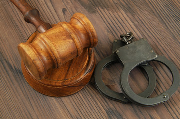 Wooden judge gavel and handcuffs