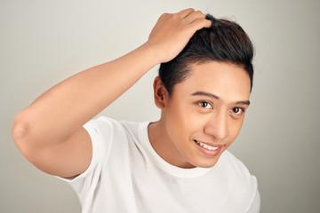 Close up portrait of  handsome Asian man touching his perfect hair