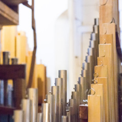 part of the church organ with many air pipes made of metal