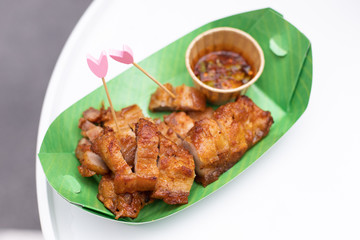 Fried pork with sauce in the box. Thai street food.