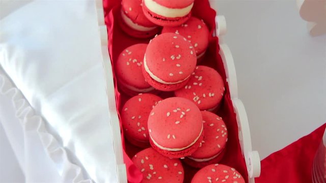 Red macaroons in the white wooden box. French macaroon cake	