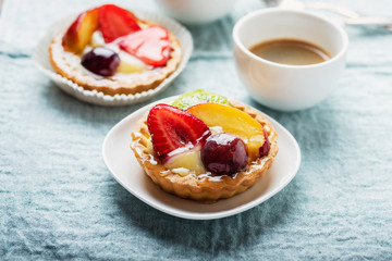 Mini tarts with cream and mix of summer fruit