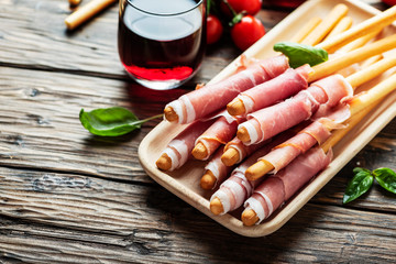 Italian antipasto with brad sticks and pork ham