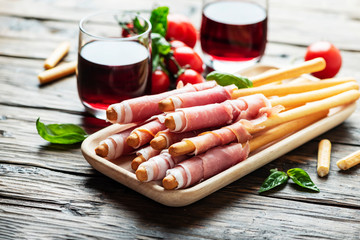 Italian antipasto with brad sticks and pork ham