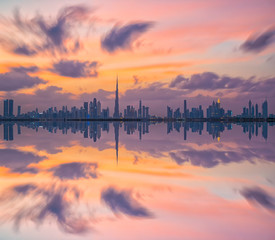 Skyline Dubai City reflection during sun-set 