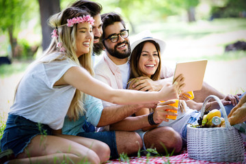 Group of young people taking a selfie outdoors, having fun