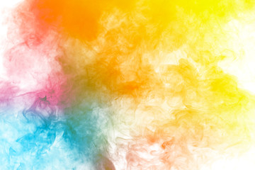 Abstract multi colored smoke flowed on black background. . Abstract yellow tone color smog clouds.