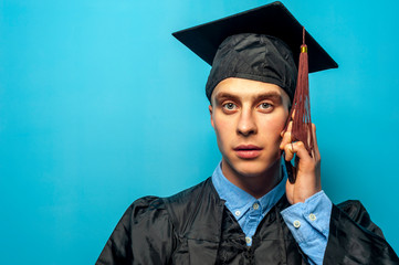 Portrait of Male student graduate on blue background