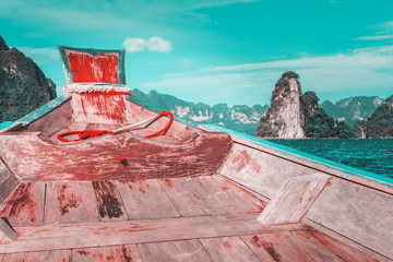 Wooden boat on sailing travel in Ratchaprapa Dam and Cheow Larn Lake, Khao Sok nature beautiful in Thailand