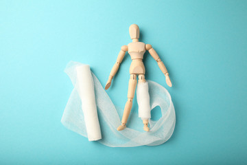 Figure of man with leg wound and white gauze bandage. First aid, injury treatment. Patient in...