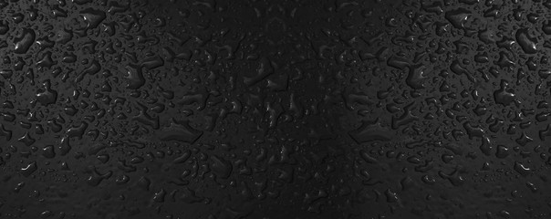 Water drops background. Close up on dew droplets with sharp focus on black surface.