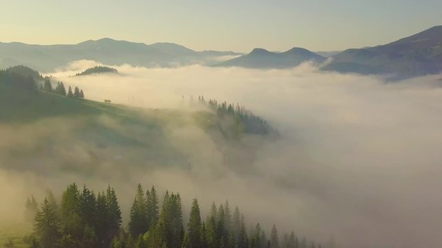 Surreal sunrise in the Smoky mountain skies. Drone video lifting up and panning to reveal the sunrise through the clouds in the Blue Ridge Great Smoky Mountains of Tennessee