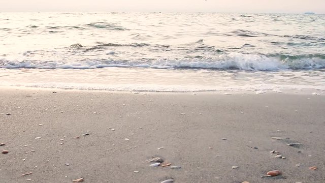 Sea waves splashing on a sunny summer day. Light breeze.