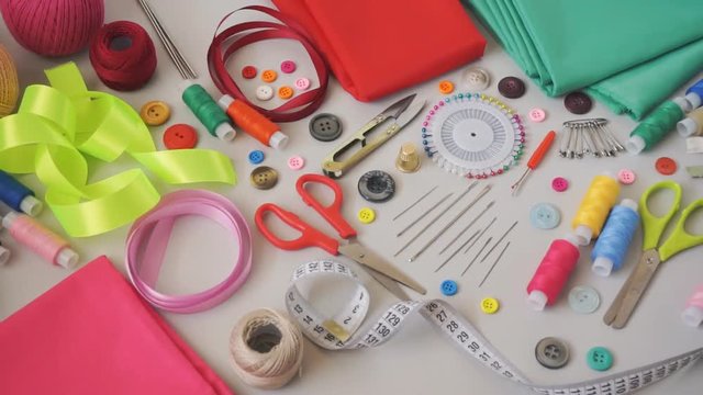 Sewing supplies and accessories for needlework. Sewing threads, needles, pins, scissors, fabric, buttons and sewing centimeter