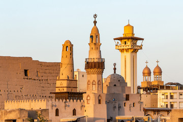 catholic Church and Muslim Mosque Tower religion Symbols together in Luxor temple at sunset