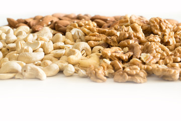 Walnuts and cashews on a completely white background.