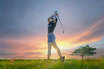 woman golf player in action setup address after hit the golf ball away from fairway to the...