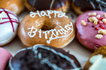happy birthday multicoloured donuts inside white box