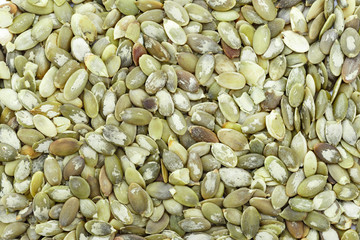 Macro background texture of green pumpkin seeds