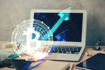 Crypto currency theme hologram with businessman working on computer on background. Concept of...