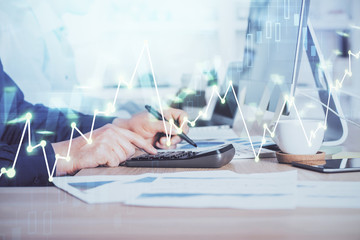 Obraz premium Forex graph with businessman working on computer in office on background. Concept of hardworking. Closeup. Multi exposure.