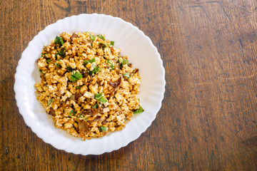 Top view fusion vegan food in Thai northern style (Larp) in white ceramic plate on wooden...
