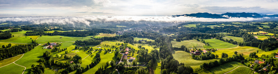 Fototapeta na wymiar Aerial Bad Toelz Bavarian Alps. Golf Course. Blomberg Mountain. Morning Drone Shot with some clouds in the sky