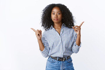Girl asking opinion what product buy pointing sideways both left right consulting facing decision,...