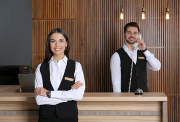 Receptionist at desk with colleague in lobby