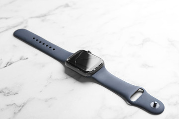 Broken smart watch on marble background. Repair service