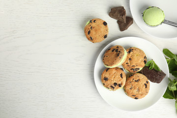 Sweet delicious ice cream cookie sandwiches served on table, flat lay. Space for text