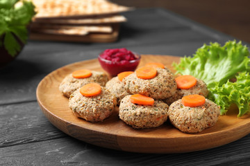 Plate of traditional Passover (Pesach) gefilte fish on wooden table, closeup