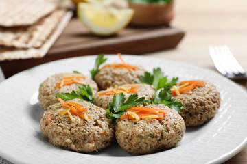 Plate of traditional Passover (Pesach) gefilte fish on table, closeup