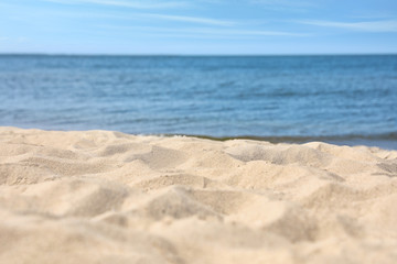Naklejka na ściany i meble Sandy beach near sea on sunny day
