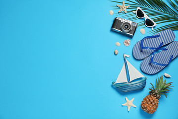Flat lay composition with beach accessories on color background, space for text