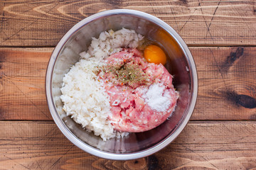 Step-by-step cooking meatballs with rice in tomato and vegetable sauce - step 2 - mixing the...