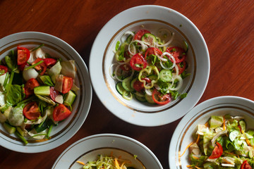 Several salads with vegetables and greens. Healthy food concept. Mixed vegetables