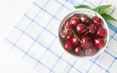 Fresh cherry on plate on wooden white background. fresh ripe cherries. sweet cherries.